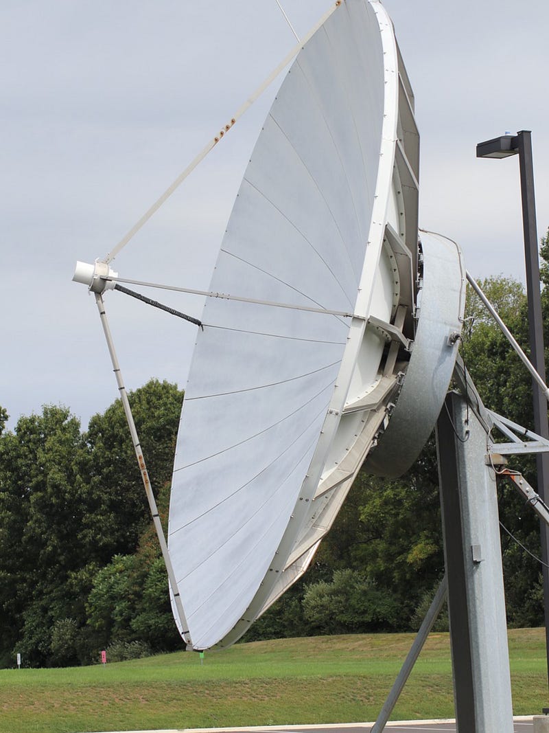 Father contemplating his giant satellite dish