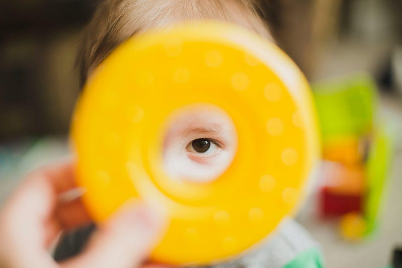 Baby examining a toy closely