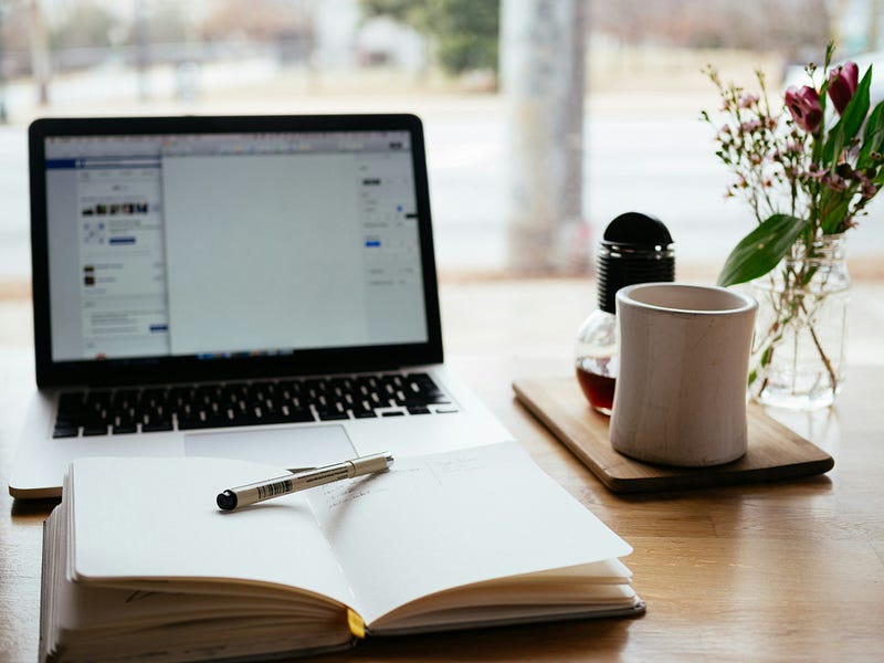 Writer's desk with open books and pen