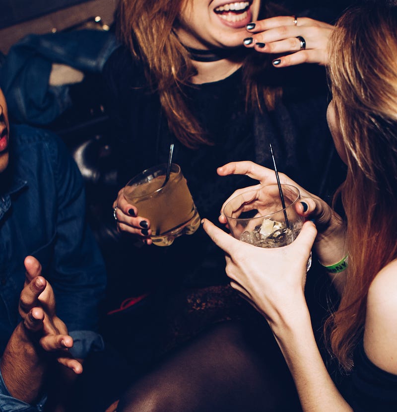 Young adults enjoying drinks at a bar